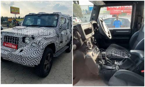 Five-Door Mahindra Thar Spied Again; Interior Details Revealed पांच दरवाजों वाली थार का कैबिन अतिरिक्त दरवाजों और लंबे व्हीलबेस के साथ तीन दरवाजों वाले मॉडल के समान दिखती है, जो पीछे की तरफ अधिक जगह जोड़ता है.